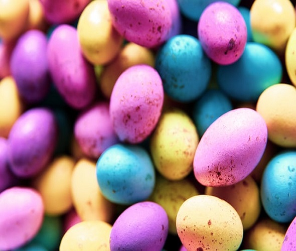 A pile of pink, blue and yellow easter eggs.